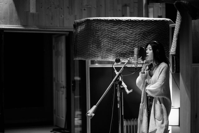 Vancouver based singer songwriter Wanting Qu in the recording studio with her band