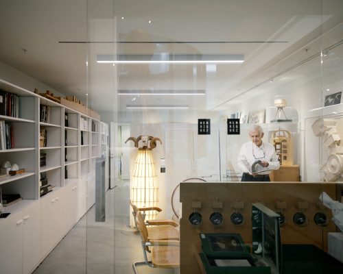 Wide angle photo of Richard Henriquez, founding principal of Henriquez Partners Architects at work in his office in Vancouver, BC.