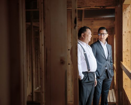 Two men conduct a site visit of a property under construction in Vancouver, British Columbia