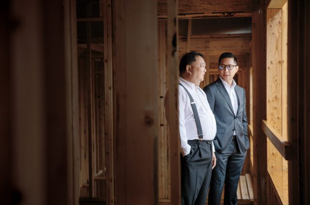Two men conduct a site visit of a property under construction in Vancouver, British Columbia
