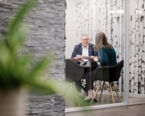 A male and female in conversation inside of an office