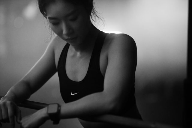 Asian woman working out in Vancouver indoor gym wearing nike pro clothing