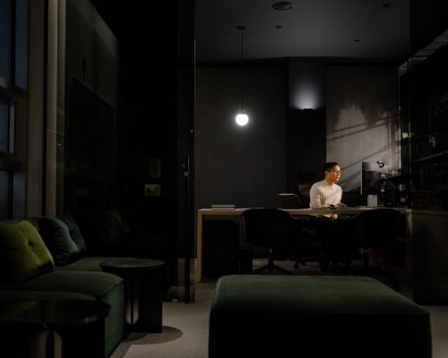 Young asian male executive works on his computer in his office